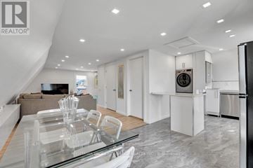 Ottawa duplex for rent - A modern kitchen with a glass dining table and a refrigerator.