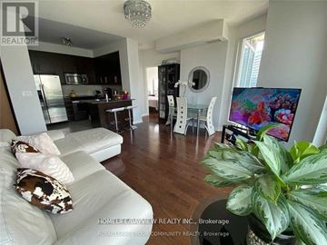 Toronto (Willowdale East) condo for rent - A living room with a white couch and a television.