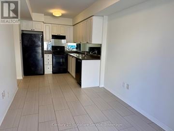 Mississauga (Churchill Meadows) townhouse for rent - A kitchen with white cabinets and black appliances.