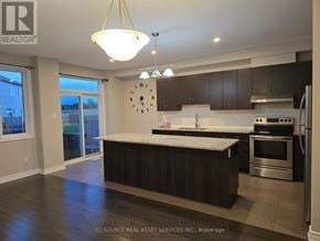 Ottawa townhouse for rent - A kitchen with a large island and a clock on the wall.