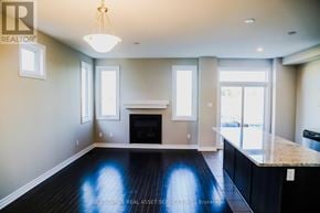Ottawa townhouse for rent - A well-lit, spacious living room with a fireplace and a large window.