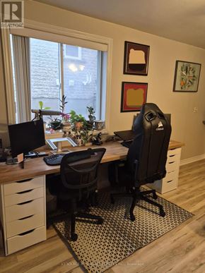 Guelph (Pineridge/Westminster Woods) apartment for rent - A home office with a desk, chairs, and a window.