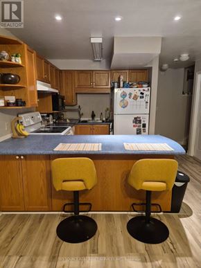 Guelph (Pineridge/Westminster Woods) apartment for rent - A kitchen with wooden cabinets and a blue countertop.