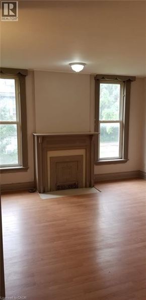 Chatham apartment for rent - A room with a fireplace and wooden floors.