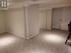 Mississauga (Central Erin Mills) apartment for rent - A room with white walls and a tiled floor.