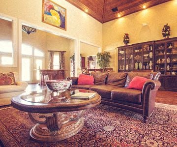 Greenville apartment for rent - A living room with a brown couch and a glass coffee table.
