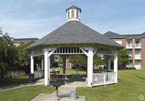 Greenville apartment for rent - A gazebo with a white frame and a black roof is surrounded by a white picket fence.