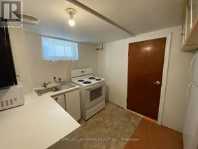 Toronto (East York) apartment for rent - A small kitchen with a sink, stove, and oven.