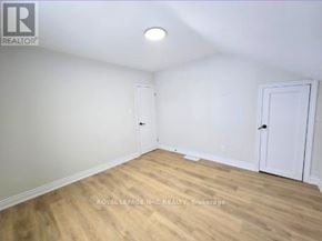 Port Colborne (East Village) fourplex for rent - A room with wooden flooring and two white doors.