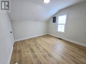 Port Colborne (East Village) fourplex for rent - A room with wooden flooring and a window.