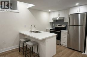Hamilton apartment for rent - A kitchen with a white countertop and a stainless steel refrigerator.