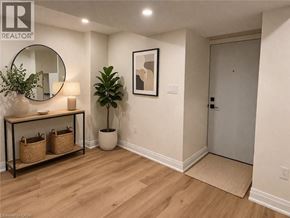 Hamilton apartment for rent - A room with a mirror, a potted plant, and a framed picture on the wall.