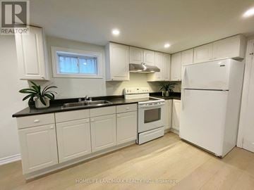 Toronto (Willowridge-Martingrove-Richview) apartment for rent - A kitchen with white cabinets and appliances.