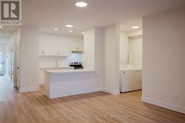 Welland (Lincoln/Crowland) multi-family for rent - A kitchen with white cabinets and a white island in the middle.