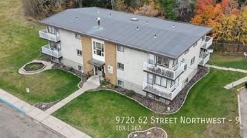 Edmonton apartment for rent - An aerial view of a two-story house with a grey roof and a brown door.