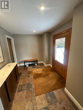 Blue Mountains apartment for rent - A room with a tiled floor and a wooden door.
