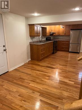 Whitby (Blue Grass Meadows) apartment for rent - A kitchen with wooden floors and white walls.