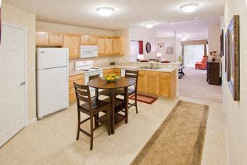 Fort Wayne apartment for rent - A kitchen with a table and chairs in the middle of the room.