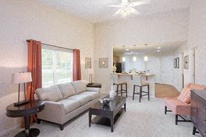 Fort Wayne apartment for rent - A living room with a couch, chairs, and a dining table.