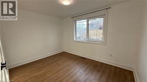 Newmarket apartment for rent - A room with a window and wooden flooring.