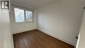 Newmarket apartment for rent - A room with a window and wooden flooring.