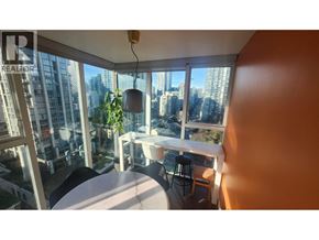Vancouver apartment for rent - A balcony with a table and chairs overlooking a cityscape.