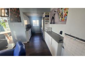 Vancouver apartment for rent - A blue couch sits in a room with a white counter and a calendar on the wall.