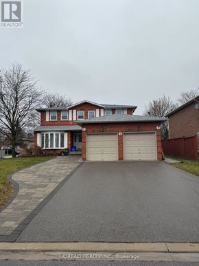 Markham (Sherwood-Amberglen) apartment for rent - A red brick house with a white garage door.