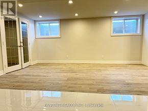 Markham (Sherwood-Amberglen) apartment for rent - A spacious room with wooden flooring and two windows.