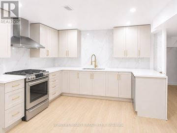 Toronto (West Hill) apartment for rent - A kitchen with white cabinets and a stainless steel range hood.