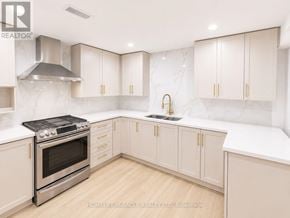 Toronto (West Hill) apartment for rent - A kitchen with white cabinets and a marble backsplash.