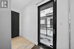 Innisfil townhouse for rent - A black door with a glass window showing a snowy scene outside.