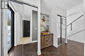 Innisfil townhouse for rent - A modern interior space with a wooden floor and a staircase.