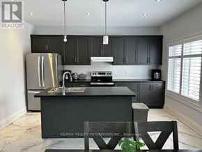 Blue Mountains apartment for rent - A modern kitchen with a large island and stainless steel appliances.