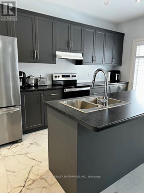 Blue Mountains apartment for rent - A kitchen with a sink, refrigerator, and stove.