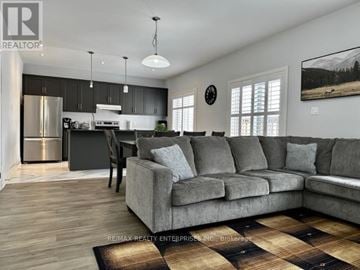 Blue Mountains apartment for rent - A living room with a grey couch and a wooden floor.