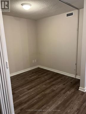 Toronto (Bayview Village) condo for rent - A room with wood flooring and a door on the right side.