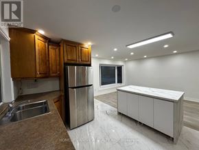 Newmarket (Bristol-London) apartment for rent - A kitchen with wooden cabinets and a marble island.