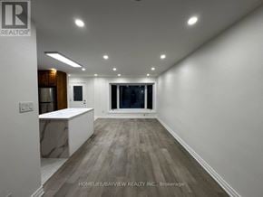 Newmarket (Bristol-London) apartment for rent - A kitchen with a white island in the middle of the room.