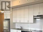 Brampton (Bram West) condo for rent - A kitchen with white cabinets and a stainless steel counter.