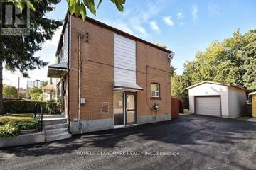 Toronto (Ionview) apartment for rent - A brick building with a garage door is for sale.