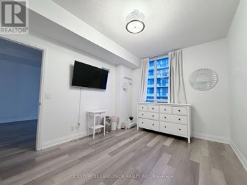 Toronto (Banbury-Don Mills) condo for rent - A bedroom with a white dresser and a flat screen TV mounted on the wall.