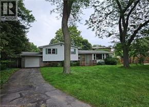 Ancaster apartment for rent - A house with a driveway and a tree in front of it.