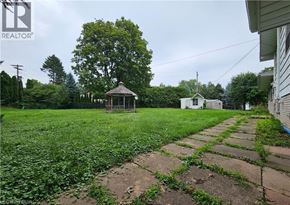 Ancaster apartment for rent - A gazebo sits in a grassy backyard with a house in the background.