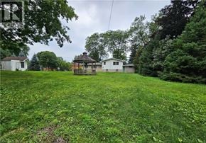 Ancaster apartment for rent - A gazebo sits in the middle of a lush green field.