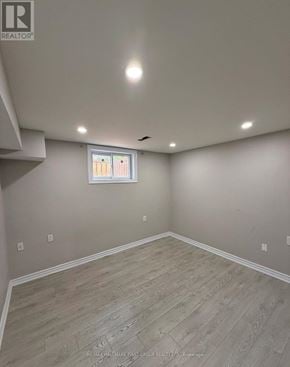 Pickering (Brock Ridge) apartment for rent - A room with a window and wooden flooring.