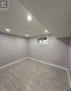 Pickering (Brock Ridge) apartment for rent - A room with a window and wooden flooring.