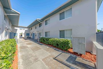 Lake Park apartment for rent - A sunny day at a residential area with apartment buildings and a clear blue sky.