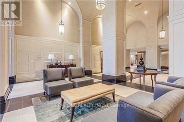 Mississauga (City Centre) condo for rent - A spacious living room with a large couch, a coffee table, and a dining table set up.