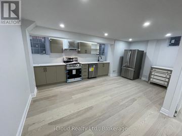 Oakville (Go Glenorchy) apartment for rent - A kitchen with wooden flooring and a refrigerator.